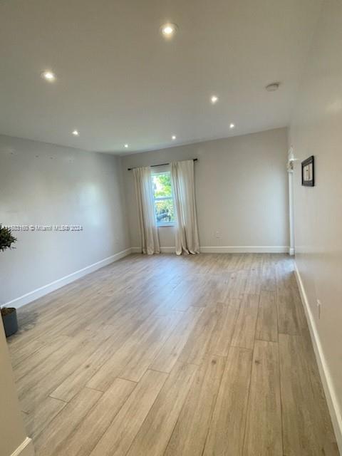 Glenvar Heights Miami, FL 33143 - Photo 7 of 14 an empty room with wooden floor and windows
