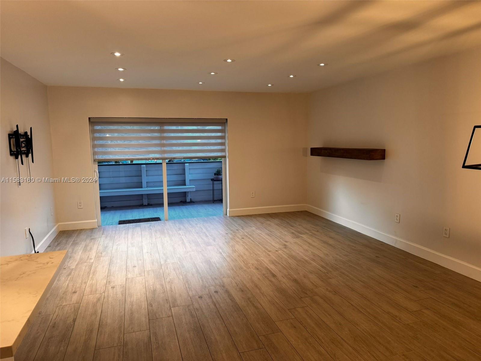 Glenvar Heights Miami, FL 33143 - Photo 9 of 14 wooden floor in an empty room with a window