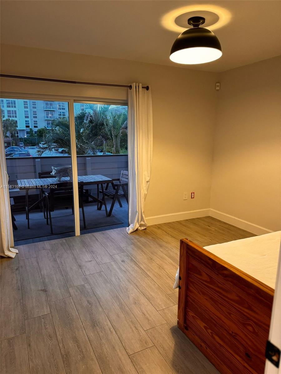 Glenvar Heights Miami, FL 33143 - Photo 10 of 14 an empty room with wooden floor and windows