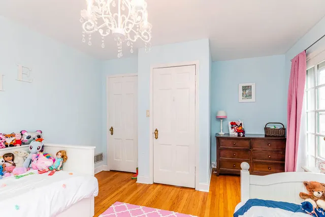 a bedroom with a bed and a chandelier