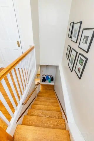 a view of staircase with lots of frames on wall