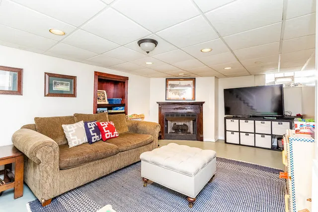 a living room with furniture a flat screen tv and a fireplace