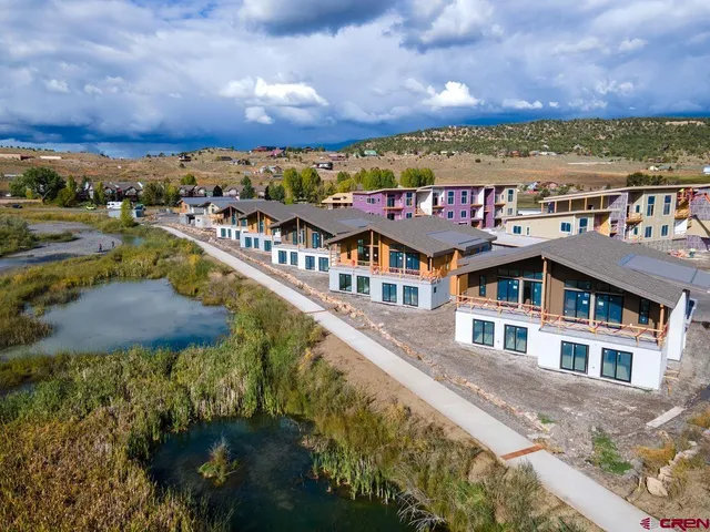 an aerial view of residential houses and lake