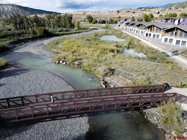 a bedroom with two beds and a large window