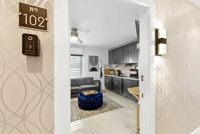 a kitchen with stainless steel appliances a refrigerator a sink a stove and a microwave