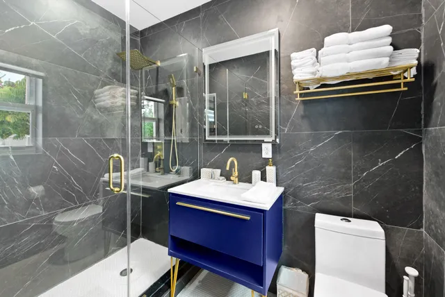 a bathroom with a sink toilet and shower