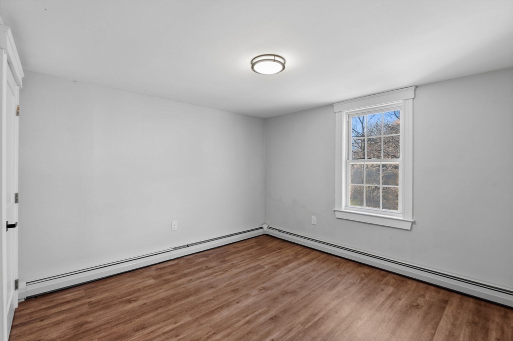 99 Mason Street, Unit 2 Salem, MA 01970 - Photo 12 of 25 an empty room with wooden floor and windows