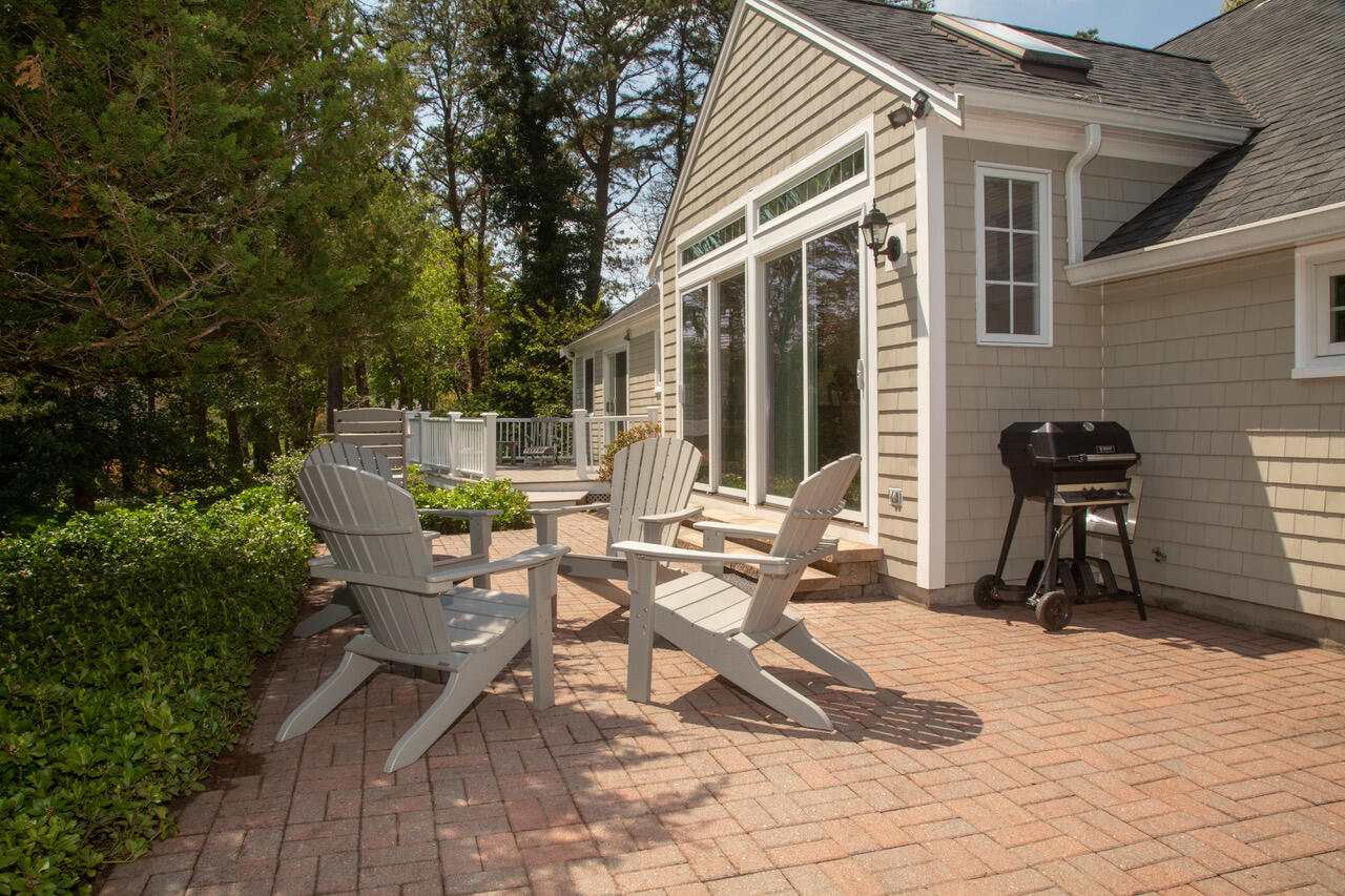 21 Midpine Road Cummaquid, MA 02675 - Photo 13 of 32 a view of a patio with table and chairs and potted plants
