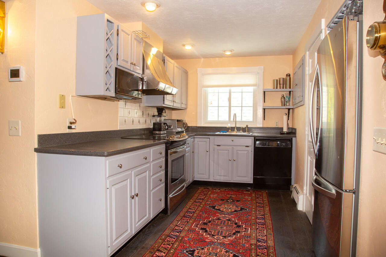 21 Midpine Road Cummaquid, MA 02675 - Photo 14 of 32 a kitchen with stainless steel appliances granite countertop a sink stove and refrigerator