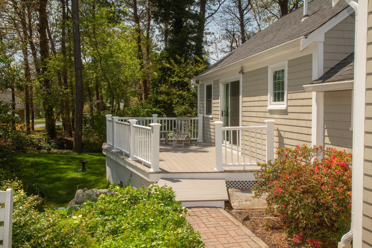 21 Midpine Road Cummaquid, MA 02675 - Photo 21 of 32 a white house with trees in front of it