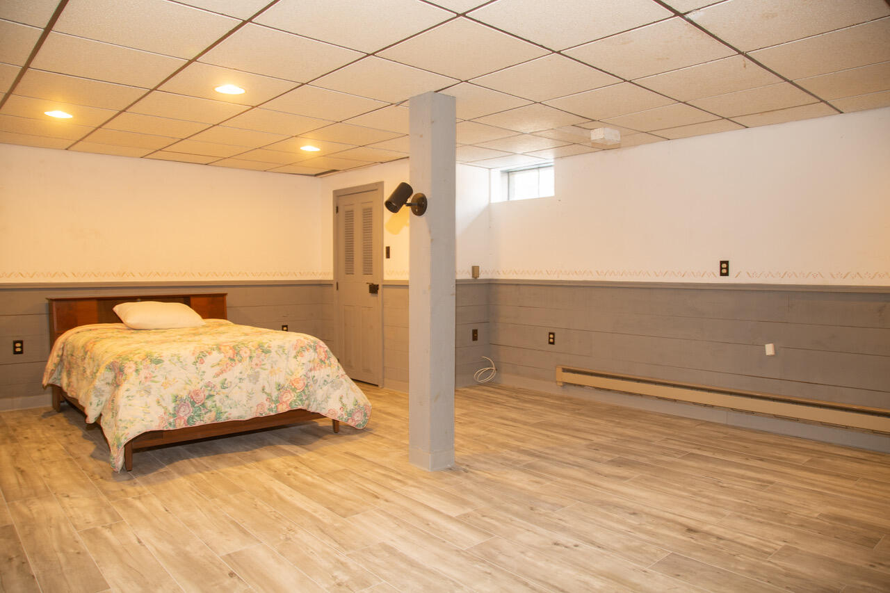 21 Midpine Road Cummaquid, MA 02675 - Photo 27 of 32 a bedroom with a bed and a night stand