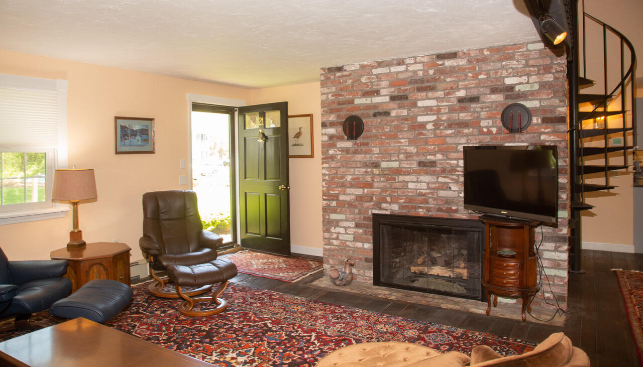 21 Midpine Road Cummaquid, MA 02675 - Photo 8 of 32 a living room with furniture a flat screen tv and a fireplace