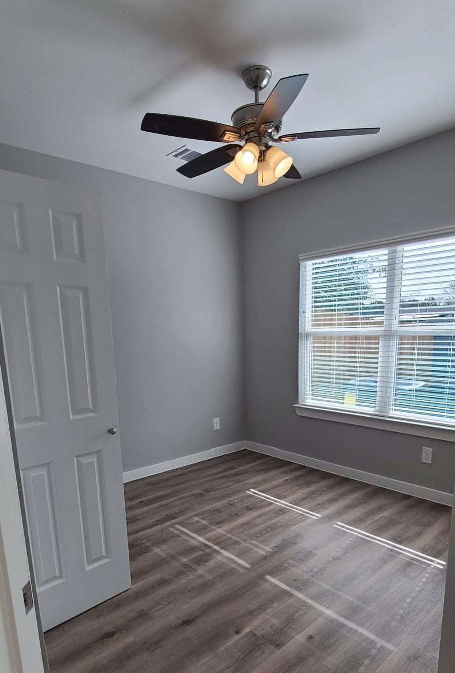 9114 Caddo Road, Unit A & B Houston, TX 77078 - Photo 18 of 24 A well-lit room offers durable flooring, a refreshing ceiling fan, and ample window light.