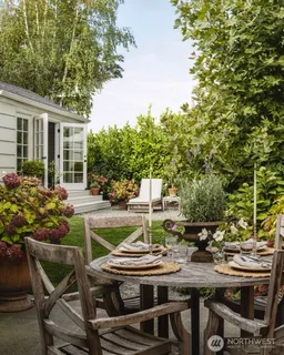 a view of a house with backyard and sitting area