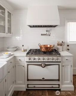 a stove top oven sitting inside of a kitchen