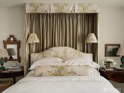 a bedroom with a bed and a chandelier