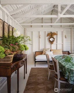 a living room with furniture and flowers