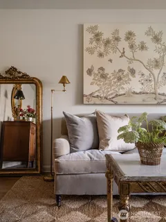 a living room with furniture and flowers