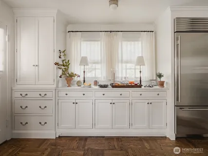 a bathroom with white cabinets and a sink