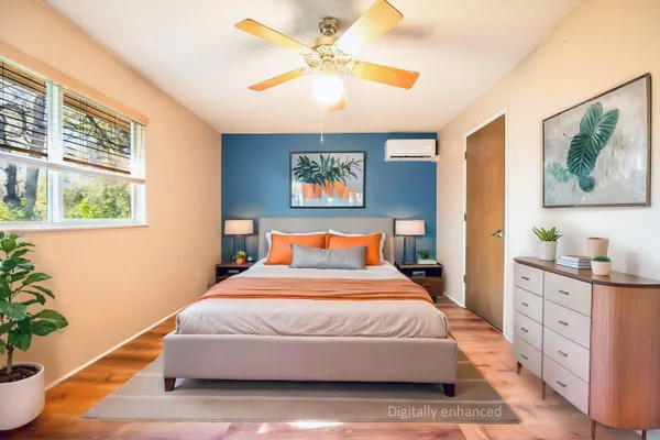 a bedroom with a bed and a painting on the wall