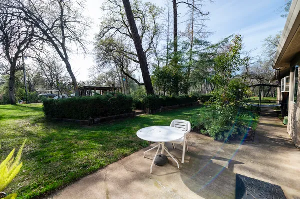 a view of a backyard with sitting area