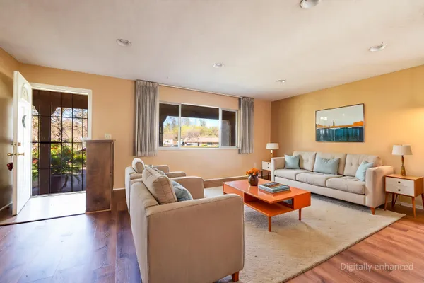 a living room with furniture and a wooden floor