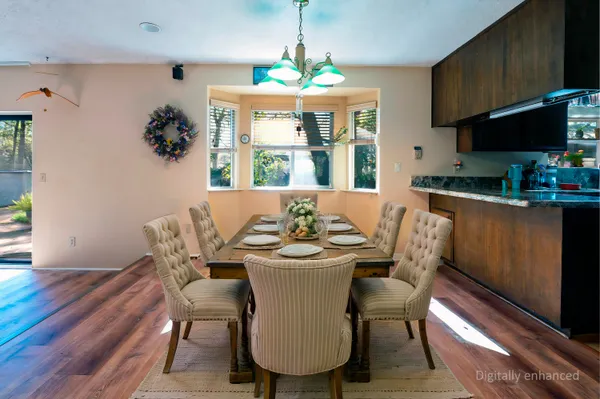 a dining room with furniture a window and wooden floor
