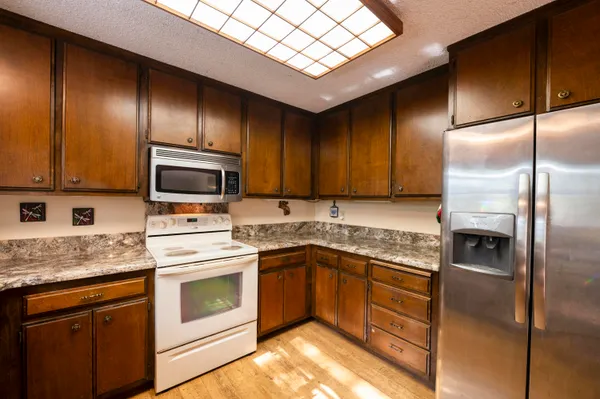 a kitchen with a sink stove and refrigerator