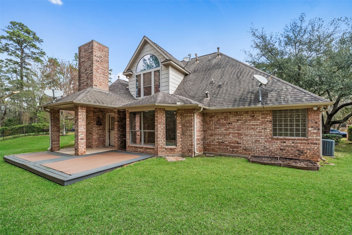 901 Longmire Road, Unit 28 Conroe, TX 77304 - Photo 12 of 31 a front view of a house with a yard table and chairs