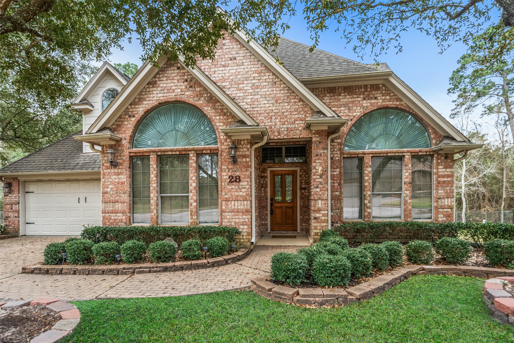 901 Longmire Road, Unit 28 Conroe, TX 77304 - Photo 14 of 31 a front view of a house with a yard and potted plants
