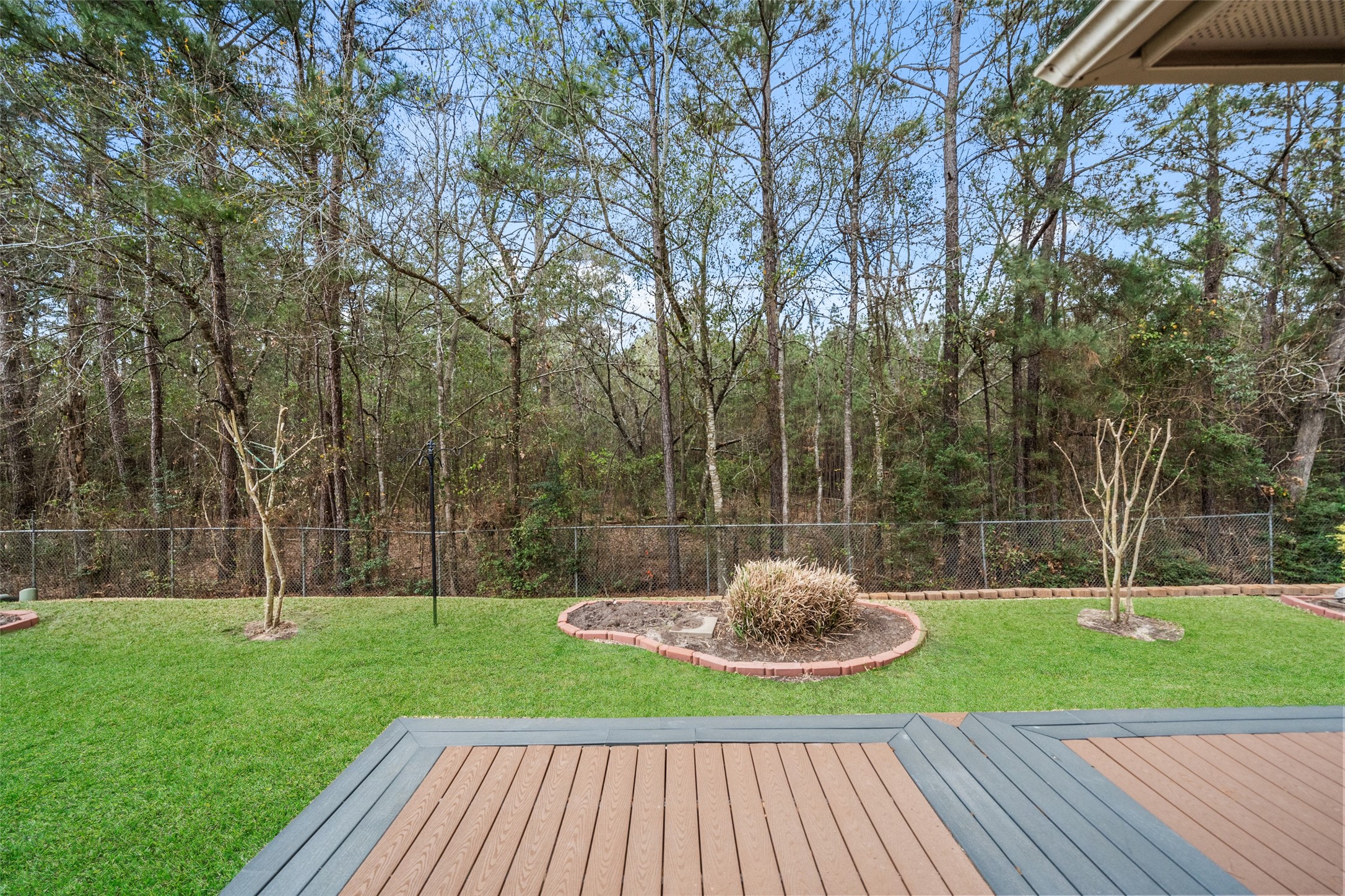 901 Longmire Road, Unit 28 Conroe, TX 77304 - Photo 21 of 31 a view of a backyard with a garden and entertaining space