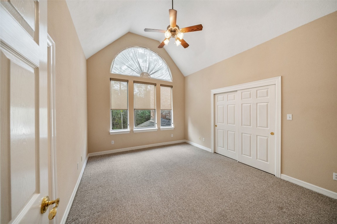 901 Longmire Road, Unit 28 Conroe, TX 77304 - Photo 25 of 31 an empty room with a window and a chandelier