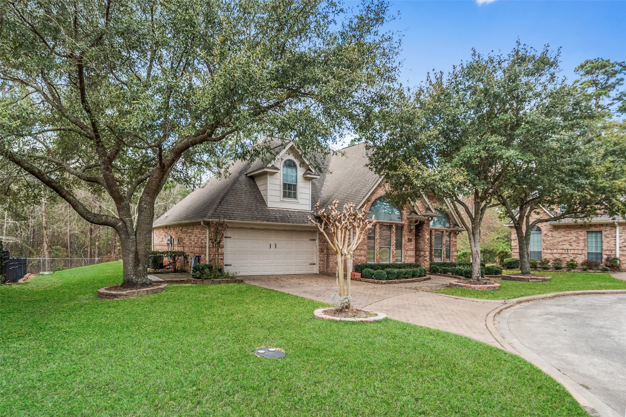 901 Longmire Road, Unit 28 Conroe, TX 77304 - Photo 30 of 31 a front view of a house with garden