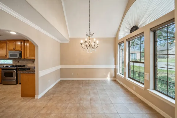 a view of a kitchen with a stove cabinets and a floor to ceiling window