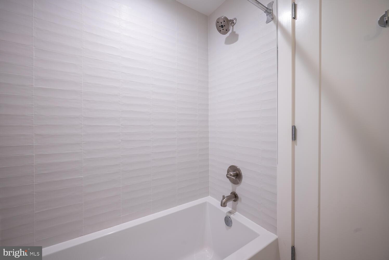 2419 Ontario Road Northwest, Unit T02 Washington, DC 20009 - Photo 11 of 17 Crisp white tile + tub