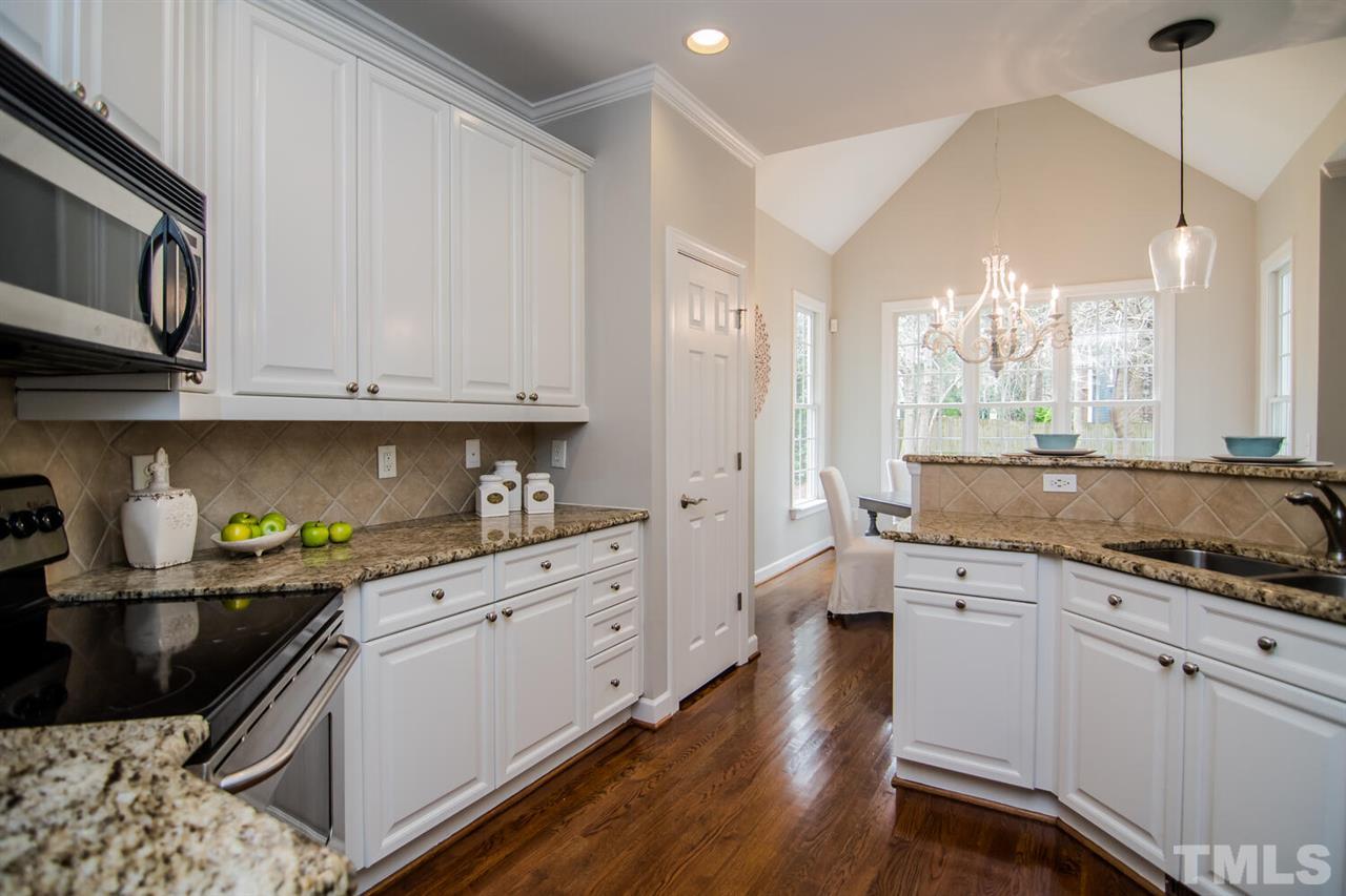 1614 Weatherford Circle Raleigh, NC 27604 - Photo 1 of 12 Beautifully updated kitchen! Gleaming HARDWOODS with Granite counters, TILE back splash and STAINLESS appliances. There's a large pantry and its open to the breakfast and family rooms.