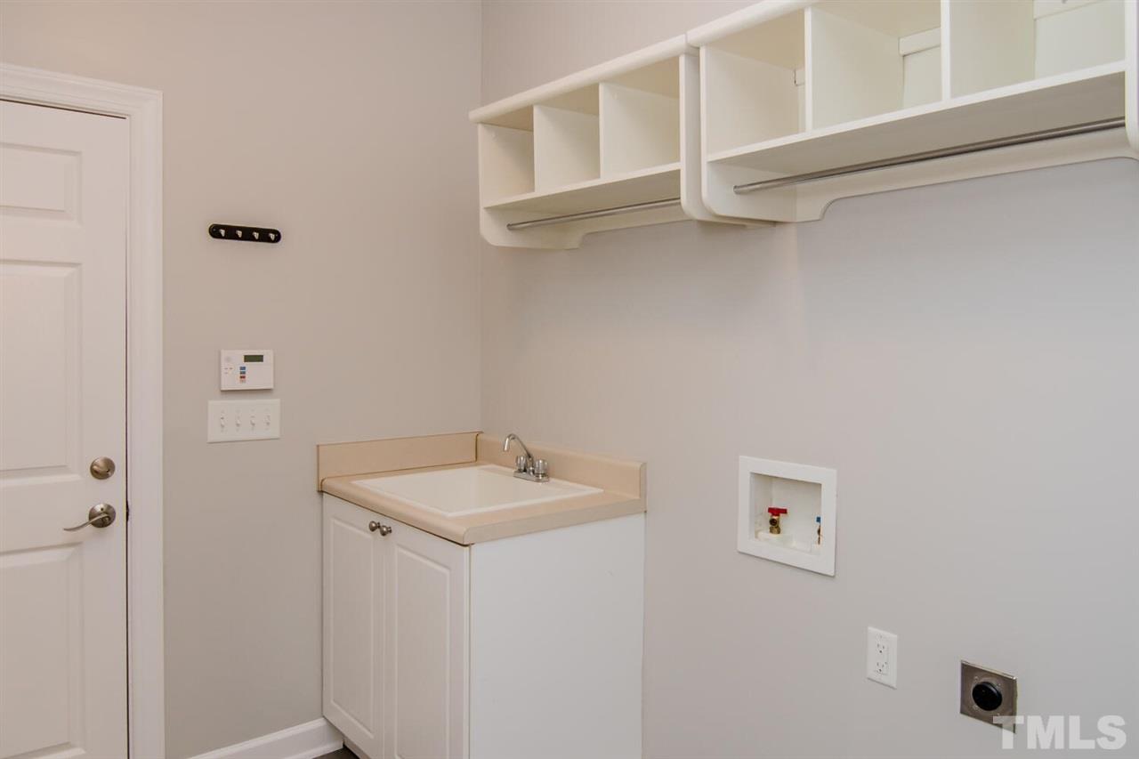 1614 Weatherford Circle Raleigh, NC 27604 - Photo 8 of 12 The laundry room is off the garage - so convenient! There are storage shelves/bins and a large utility sink.