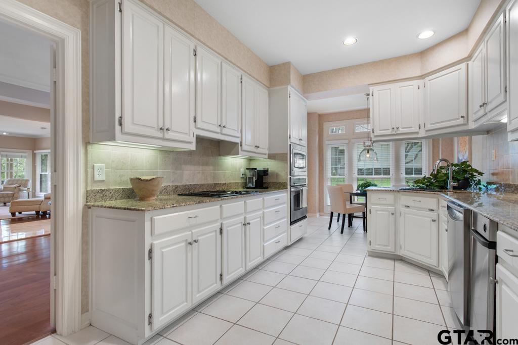 4608 North O'Connor Road Irving, TX 75062 - Photo 13 of 45 a kitchen with cabinets and chairs