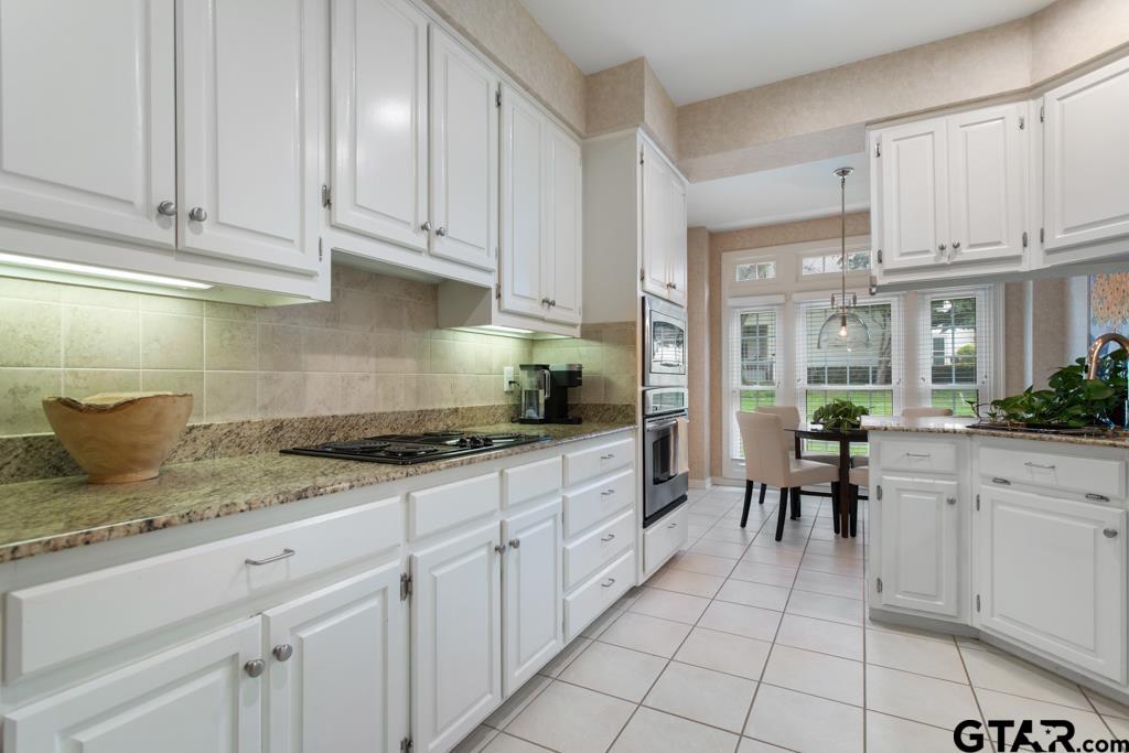 4608 North O'Connor Road Irving, TX 75062 - Photo 14 of 45 a kitchen with granite countertop white cabinets and white appliances