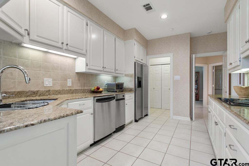 4608 North O'Connor Road Irving, TX 75062 - Photo 15 of 45 a kitchen with stainless steel appliances granite countertop a sink and a refrigerator