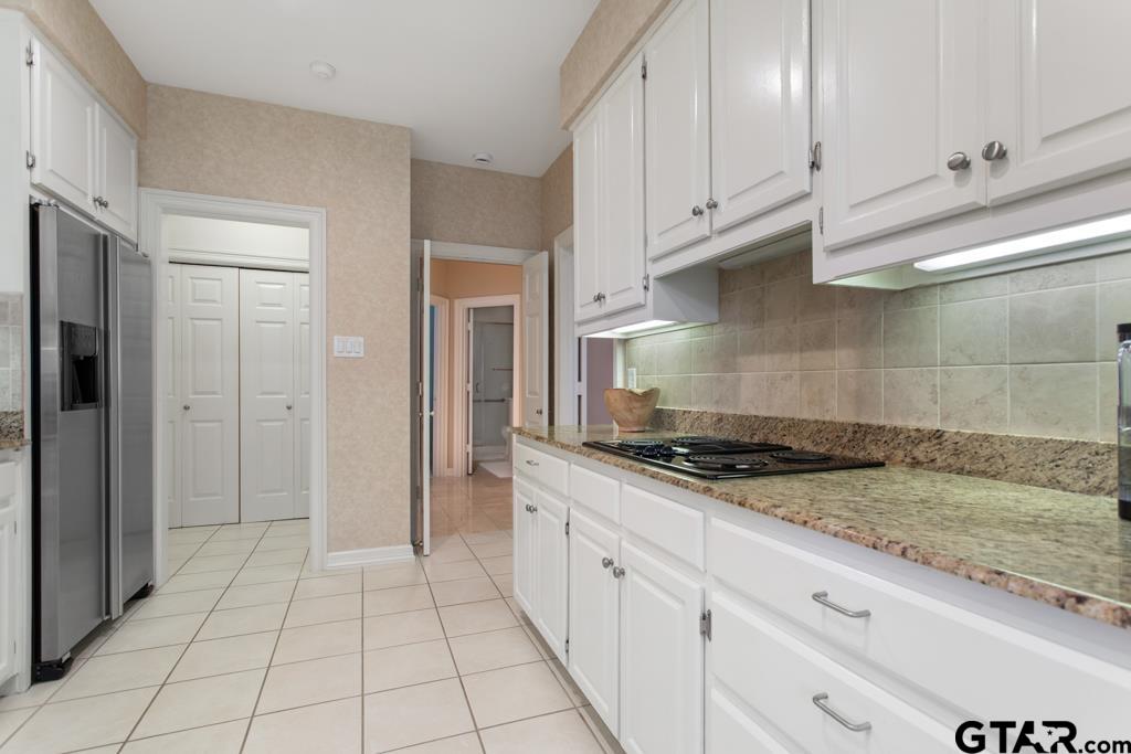 4608 North O'Connor Road Irving, TX 75062 - Photo 17 of 45 a kitchen with granite countertop a stove a sink and a refrigerator
