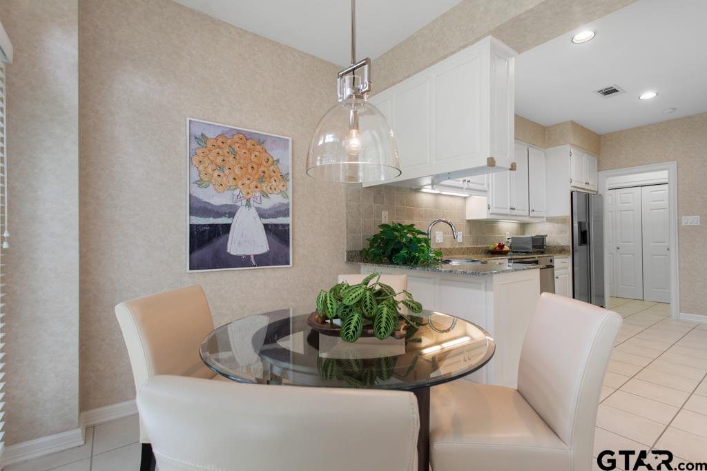 4608 North O'Connor Road Irving, TX 75062 - Photo 19 of 45 a dining room with furniture and a chandelier