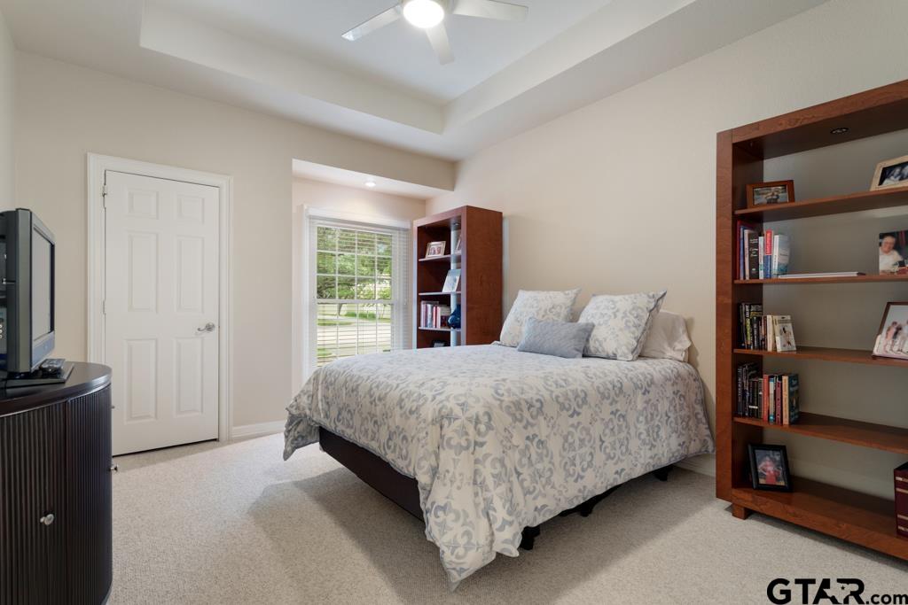 4608 North O'Connor Road Irving, TX 75062 - Photo 21 of 45 a spacious bedroom with a bed and a flat screen tv