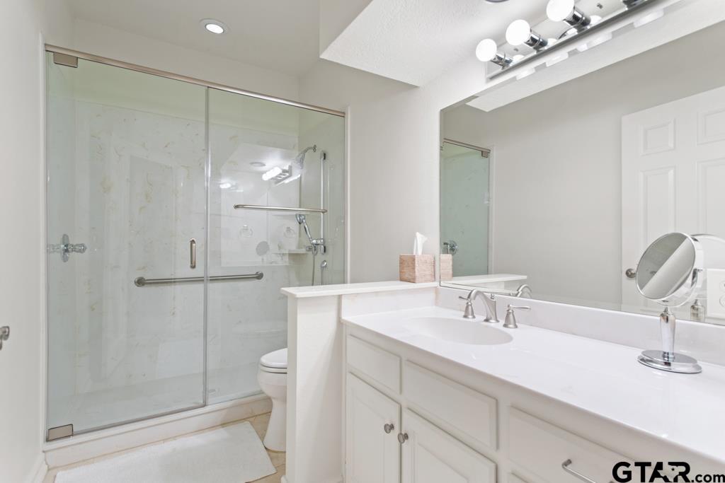 4608 North O'Connor Road Irving, TX 75062 - Photo 22 of 45 a bathroom with a shower sink vanity and toilet