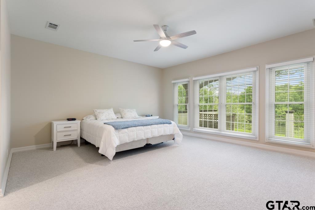 4608 North O'Connor Road Irving, TX 75062 - Photo 23 of 45 a spacious bedroom with a bed and a large window
