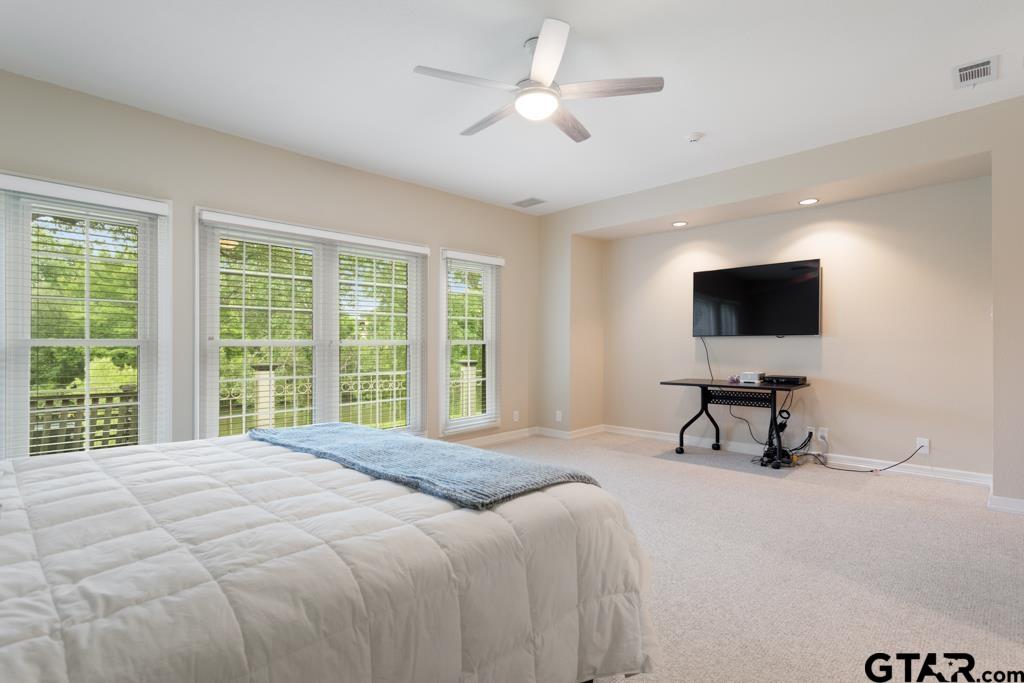 4608 North O'Connor Road Irving, TX 75062 - Photo 24 of 45 a bedroom with a bed tv and a window