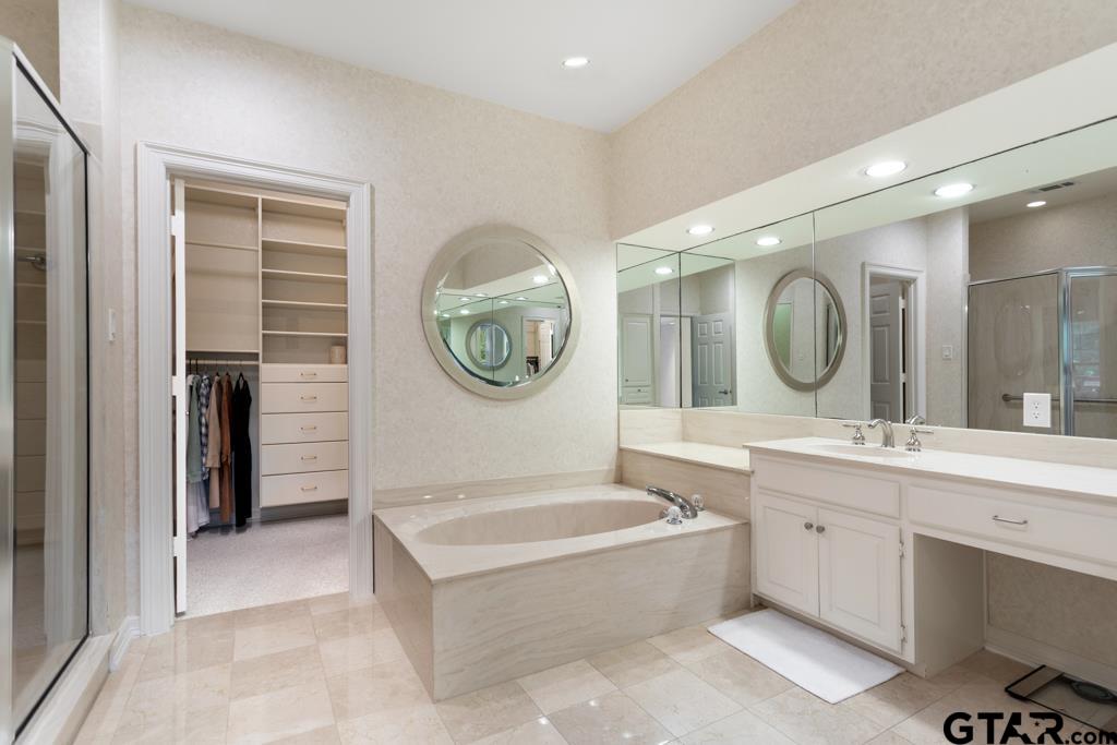 4608 North O'Connor Road Irving, TX 75062 - Photo 27 of 45 a large bathroom with a large tub sink and mirror