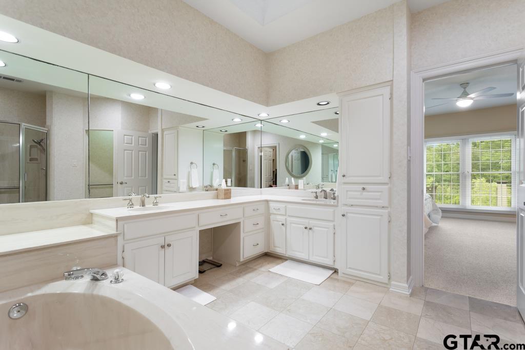 4608 North O'Connor Road Irving, TX 75062 - Photo 28 of 45 a spacious bathroom with a granite countertop sink mirror and bathtub
