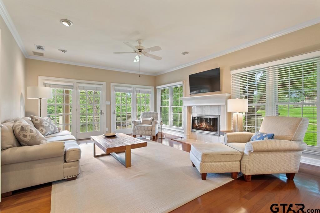 4608 North O'Connor Road Irving, TX 75062 - Photo 6 of 45 a living room with furniture floor to ceiling window hardwood floor and a flat screen tv