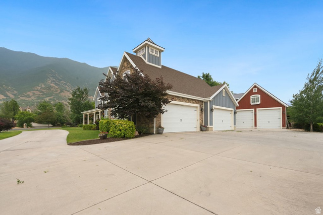 672 Perry Hollow Drive Mapleton, UT 84664 - Photo 5 of 106 Expansive concrete driveway with a primary residence featuring a cupola, stone and siding exterior, and a three-car garage